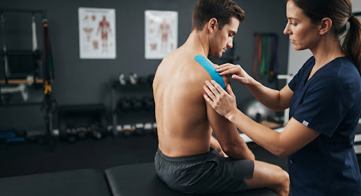 Athlete performing functional mobility and rehabilitation recovery exercises with resistance bands and exercise mat in a modern sports kinesiology studio with green turf and wood accents, active guided physical therapy, high quality sports medicine photography.